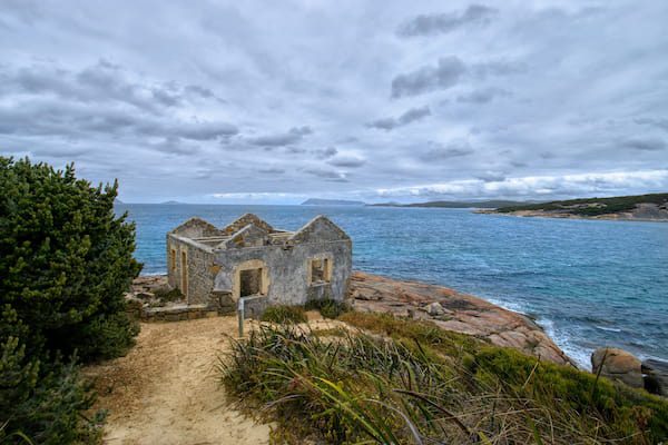 Old ruins on a rocky coastal point. 