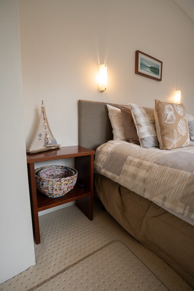 The bedside table with a model boat in the master bedroom of the Lockyer Apartment.