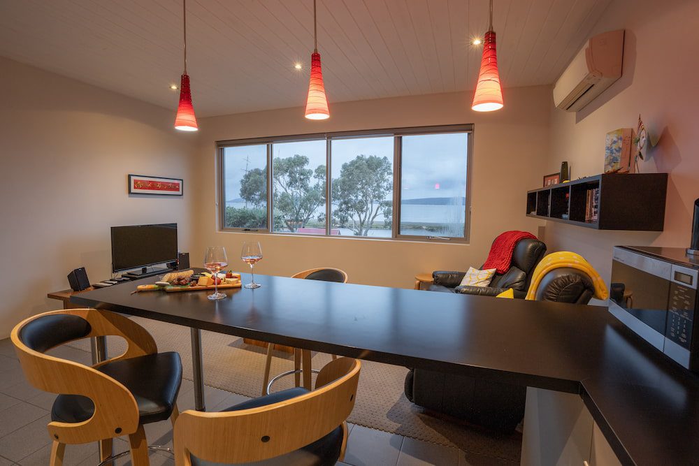 The breakfast bar of the York apartment with the view of the Princess Royal Harbour through the window.